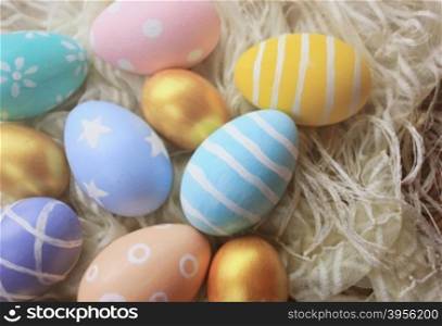 Colorful pastel easter eggs on fabric with copy space, vintage filter tone&#xA;
