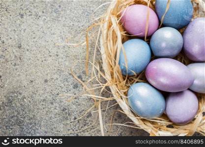 Colorful pastel easter eggs on stone background with space for text, top view.. Colorful pastel easter eggs