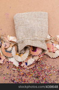 Colorful pencil shavings coming out of sack