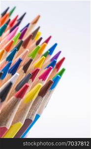 Colorful pencils in a vase on a white background