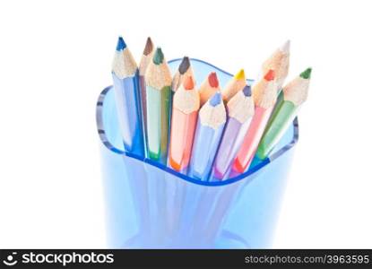 colorful pencils in glass on white background close-up