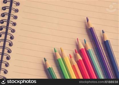 Colorful pencils in various colors on linear paper
