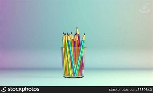 Colorful pens in studio falling into a Glass