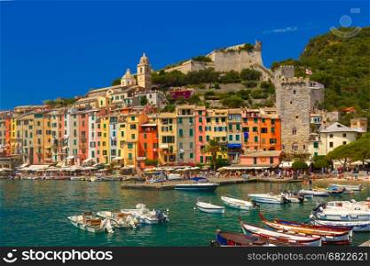 Colorful picturesque harbour of Porto Venere, San Lorenzo church and Doria Castle on the background, La Spezia, Liguria, Italy.
