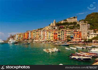 Colorful picturesque harbour of Porto Venere with San Lorenzo church, Doria Castle and Gothic Church of St. Peter, Italian Riviera, Liguria, Italy.