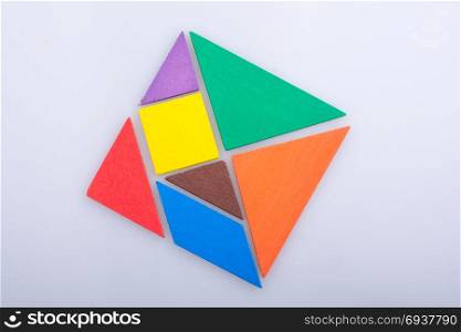 Colorful pieces of a square tangram puzzle