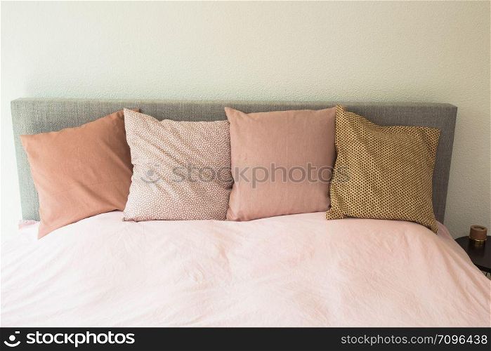 Colorful pillows ,modern bedroom with cozy double bed close-up. Colorful pillows ,modern bedroom with cozy double bed