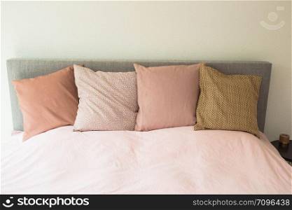 Colorful pillows ,modern bedroom with cozy double bed close-up. Colorful pillows ,modern bedroom with cozy double bed