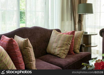 colorful pillows on red sofa in luxury living room interior