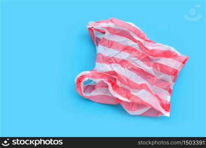 Colorful plastic bag on blue background. Copy space