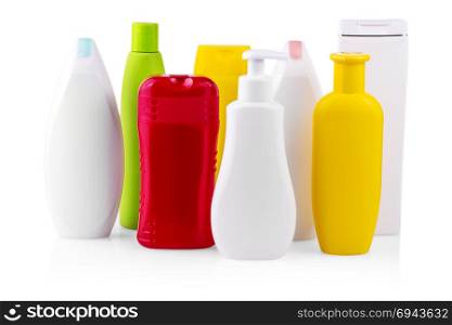 colorful plastic bottles (could be shampoo, gel, sun tan, lotion) isolated on white background