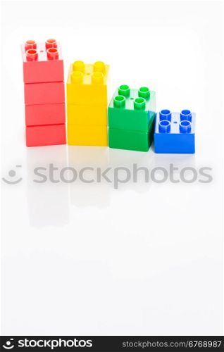 Colorful plastic building bricks on white background