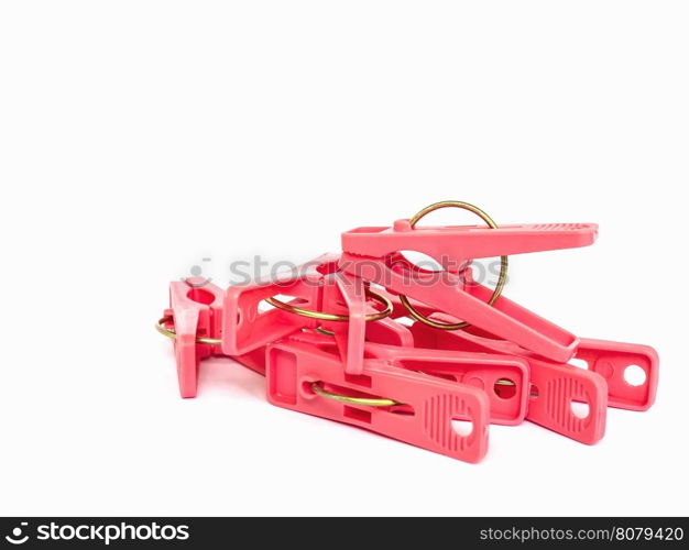 Colorful plastic clothespins over white background