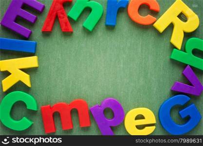 Colorful plastic letters laid on paper background