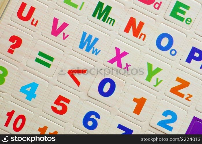 colorful plastic letters on orange background. colorful plastic letters on orange background, Top view 