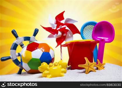 Colorful plastic toys on the beach