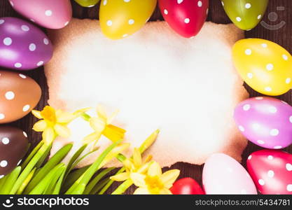 Colorful polka dot eggs and empty greeting card. Easter decorations