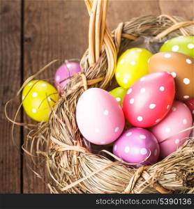 Colorful polka dot eggs in basket, Easter decorations