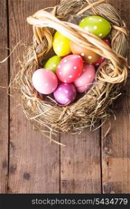 Colorful polka dot eggs in basket with copy space, Easter decorations