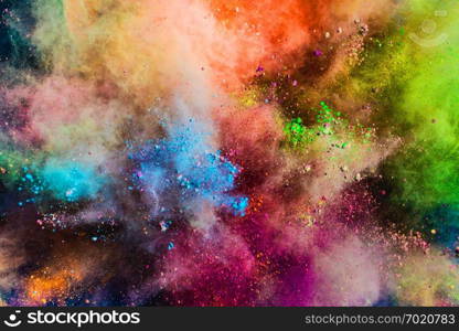 Colorful powder splashing in the air. Holi celebration. Background.. Colorful powder splashing in the air.