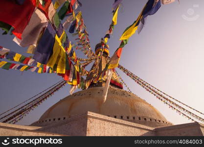 Colorful Prayer flags and Boudhanath stupa in Kathmandu. buddhism and religion