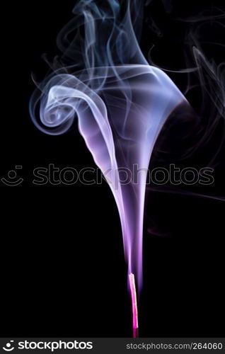 Colorful purple smoke of incence stick isolated at black background. Colorful smoke of incence stick isolated at black background
