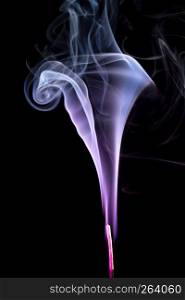 Colorful purple smoke of incence stick isolated at black background. Colorful smoke of incence stick isolated at black background