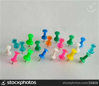Colorful push pins displayed on a white background