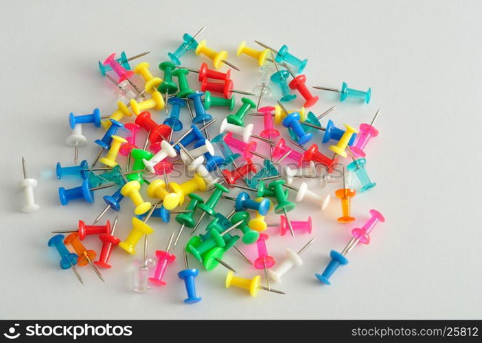 Colorful push pins displayed on a white background