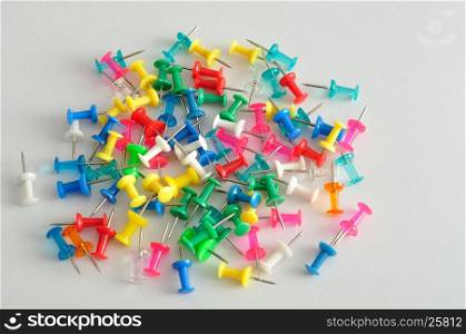 Colorful push pins displayed on a white background