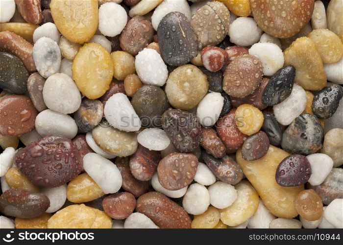 colorful river pebbles with water drops