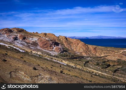 Colorful rocky hillside with path leading to the archeological site on the northern part of the Isla del Sol (Island of the Sun) in Lake Titicaca, which is a popular travel destination in Bolivia