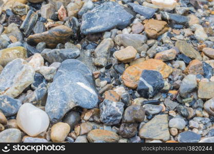 Colorful rolling stones pattern with water flowing on top