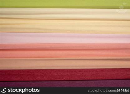 colorful rolls of crepe paper - background with crinkled texture