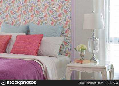 Colorful romantic bedding style with beautiful pattern headboard. Colorful romantic bedding style with beautiful pattern headboard and crystal base reading lamp