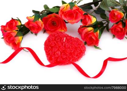 Colorful roses, candle and ribbon on white background.