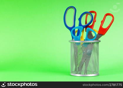 Colorful scissors on the color paper background