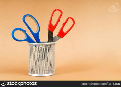 Colorful scissors on the color paper background