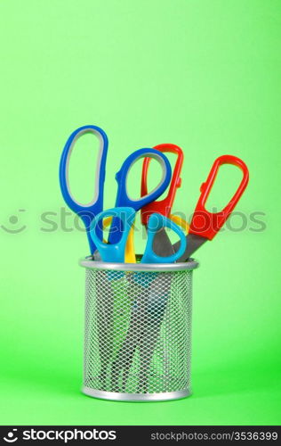 Colorful scissors on the color paper background