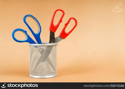 Colorful scissors on the color paper background