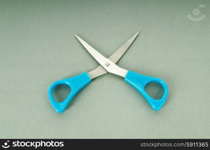 Colorful scissors on the color paper background