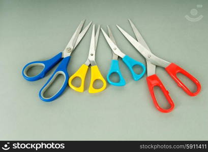 Colorful scissors on the color paper background