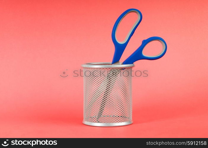 Colorful scissors on the color paper background