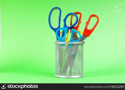 Colorful scissors on the color paper background