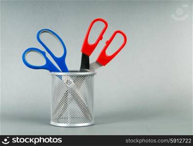 Colorful scissors on the color paper background