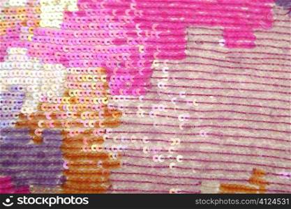 Colorful sequins macro closeup texture background sewed fabric