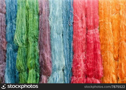 colorful silk yarns being dried. colorful silk yarns being dried full background