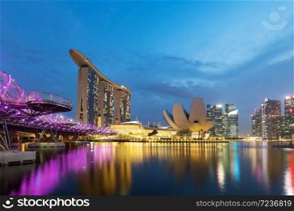 Colorful Singapore business district skyline after sun set at Marina Bay.. Colorful Singapore business district skyline.