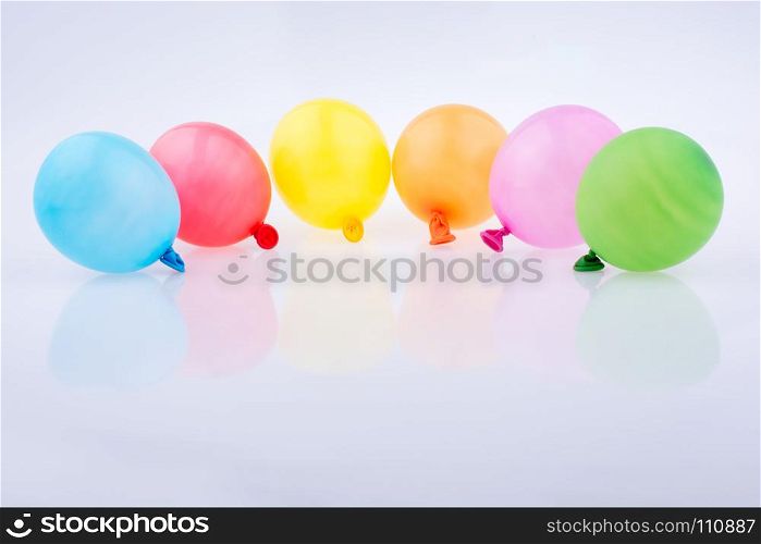 Colorful small balloons on a white background
