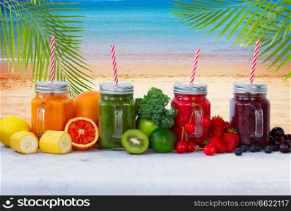 Colorful smoothy drinks in glass jars with igredients by beach. Fresh smoothy drink with igredients